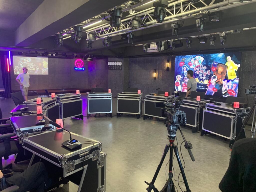 Production team filming a variety show with a live audience.